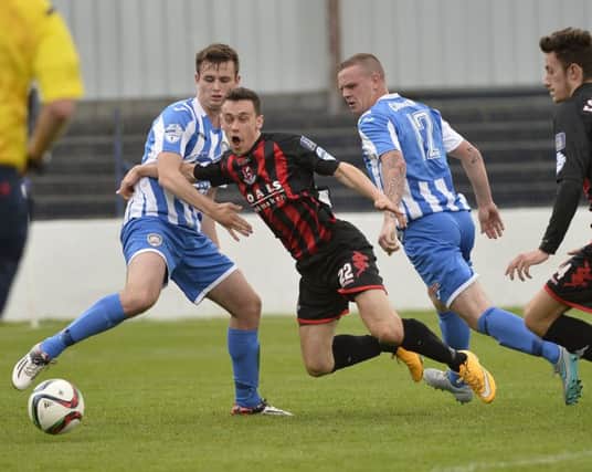 Coleraine's Adam Mullan in action with Crusaders Paul Heatley. Picture by Press Eye.com