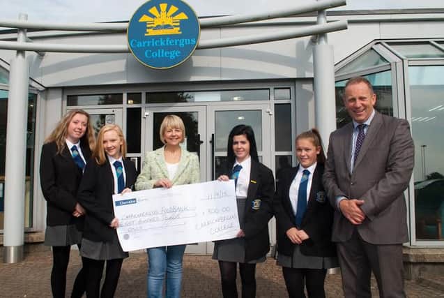 Pictured at Carrickfergus College for the cheque presentation are, from left to right, Bracken Bennett, Emma Beatty, Gwen Smyth, Carrickfergus Foodbank; Julia Hatch, Brittany Bennett and principal Hedley Webb. INCT 38-750-CON