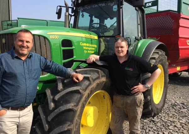Church pastor, Richard Garnham and Garth Cairns with a John Deere tractor preparing for the event