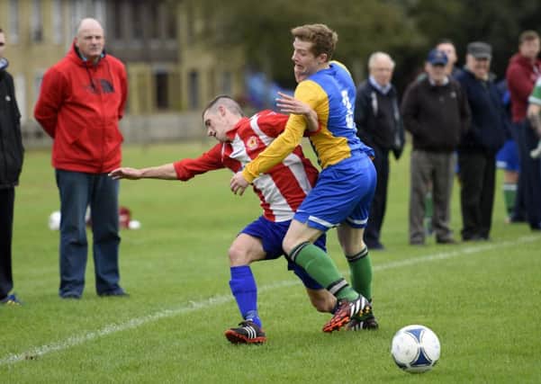 Scott Forrest, Eglinton, and Gary Harris, Lincoln Courts, tussle for the ball on Saturday. INLS3815-141KM