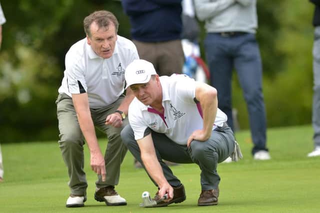John Armstrong (Greenisland) with his caddy Cyril Beatty lining up a putt at the 17th green in the AIG Junior Cup at Carton House Golf Resort. Picture: Pat Cashman