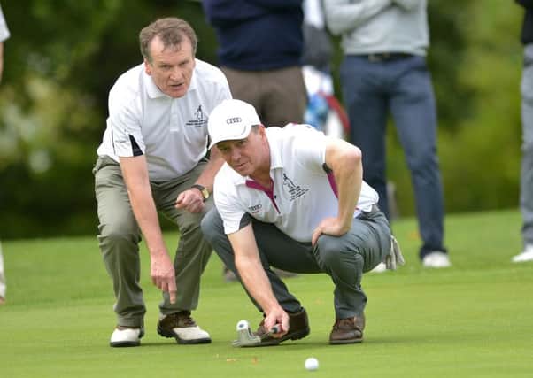 John Armstrong (Greenisland) with his caddy Cyril Beatty lining up a putt at the 17th green in the AIG Junior Cup at Carton House Golf Resort. Picture: Pat Cashman
