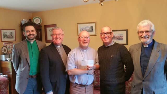 Members of the Antrim Rural Deanery with a £1061.96 cheque for the Alzheimer's Society which was raised from offerings taken at Lenten Midweek Services around the Deanery. (L-R)Rev. Andrew Ker, Rev. Ian Magowan, Rev Derek Kerr (Rural Dean), Ven Stephen McBride (Archdeacon) and Rev Paul Redfern, (absent  Rev Mark McConnell) Pic by Rev William Orr.