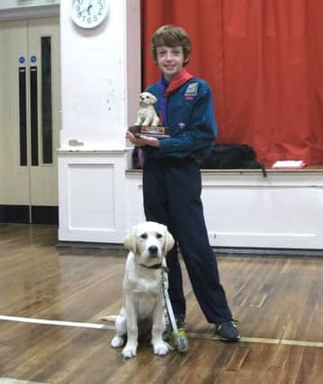 1st Ballyclare Scout Tony Montgomery with Penny the guide dog pup. INNT 40-500CON