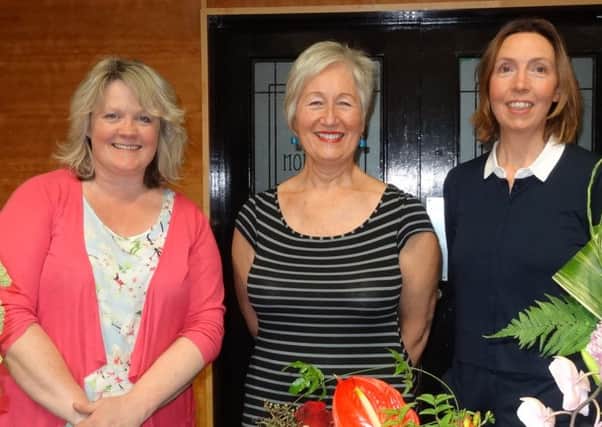 Chairman Ross McGookin (Centre) congratulates Ballymena floral Art Group members, Heather Hume (Left) and Victoria Robertson (Right) on achieving 'Area Judge' awards. INBT floral (submitted)