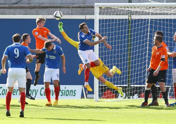 Glenavon's Rhys Marshall heads just over from this corner.