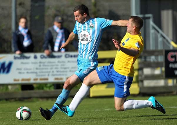 Warrenpoint Town's Stephen Murray  and Ballymena United's Johnny Taylor