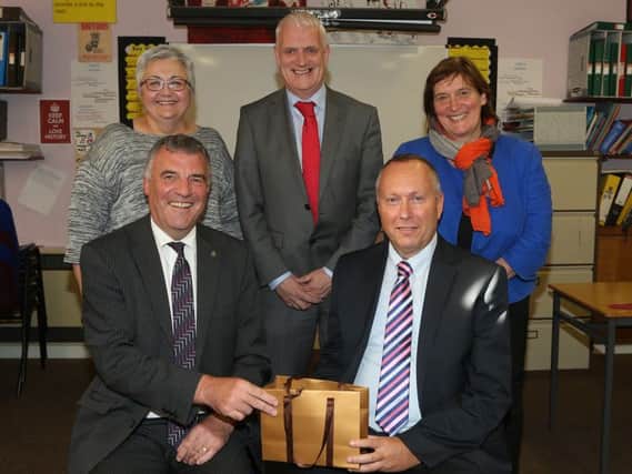 Chairman of the Ballymena Academy Board of Governors James McKervill (front left) makes a presentation to Ashley Ross who has retired after 28 years service to the school. Included are vice-chairperson of the Board of Governors Karen Johnston (left), secretary Jane Allen and principal Mr Black. INBT 41-100JC