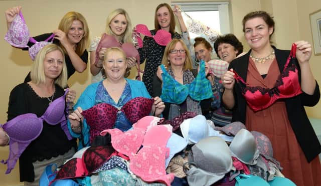 Over 200 bras have been donated by Housing Executive employees to help prevent women being sexually abused in Africa. Left to right: Avril Shields, Assistant Housing Services Manager with staff members; Tracy Collins, Patricia Kane, Olive Coates, Joanna Mc Clure, Laura Broom, Laura Thornbury, Natalie McVeigh and organiser, Joan Turkington.