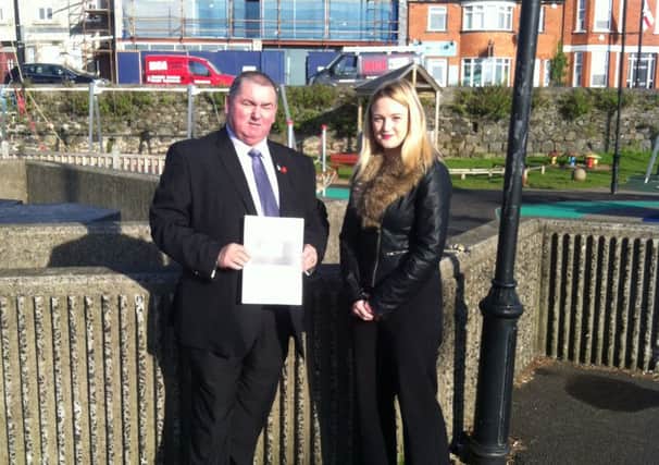 Jim McCaw from the PUP and Councillor Cheryl Johnston with the petition calling on Mid and East Antrim Borough Council to install CCTV at Marine Gardens. INCT 39-752-CON