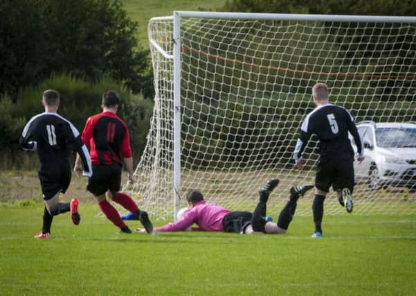 GREAT SAVE!. . . .Wanderers' netminder Conor Thornton manages to get a had to this low shot and turn it wide of the upright during Saturday's game against Limavady Drummond at Bready. INLS3815MC011