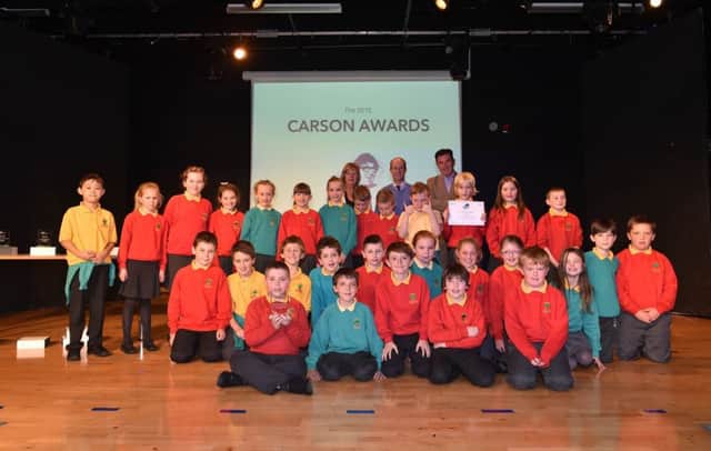 The winning class from Oakwood IPS who won a prize for their music video, 'Were All About that Peace!' at the Integrated Education Funds Carson Awards ceremony. Pictured with the children are (Centre back)  teacher Richard Mulcahy and Tony and Majella Carson.