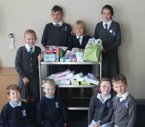 Gaelscoil an Chaistil children with donations from the school community. Many thanks to everyone who donated so generously to this important cause.