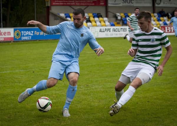 Institute striker Garbhan Friel fires in this cross despite being closed down by Lurgan Celtic's Aaron Haire on Saturday. INLS3915MC027