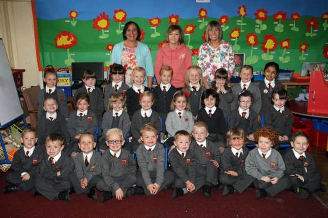 Primary 1 pupils from Antrim PS pictured with their teacher Mrs. P. Grant, classroom assistant Mrs. A. Johnston and classroom helper Laura Moffett. INBT40-219AC