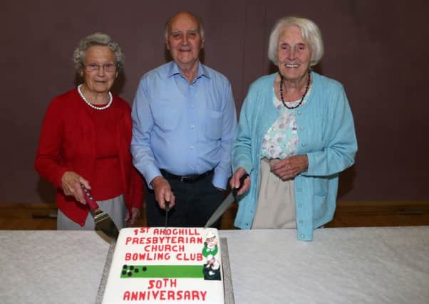 Founder member Jim McDowell is joined by vice-president Peggy Stirling (left) and president Isabel Small as they cut the special 50th birthday cake at the 1st Ahoghill Presbyterian Church Indoor Bowling Club 50th anniversary evening in the church hall. INBT 41-170CS