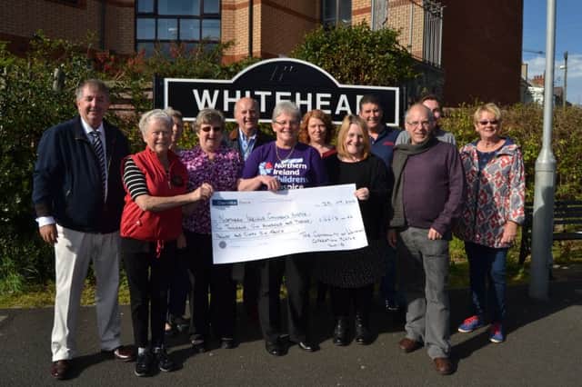 Members of the Whitehead community presenting a cheque to Catherine O'Hara, of Northern Ireland Children's Hospice, following Whitehead Summer Festival. INCT 40-705-CON