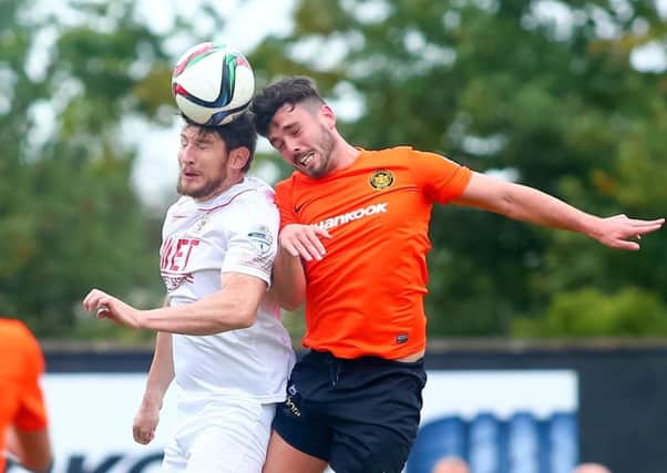 Carrick Rangers' Brian McCaul and Portadown's Ken Oman in action. Picture: Presseye