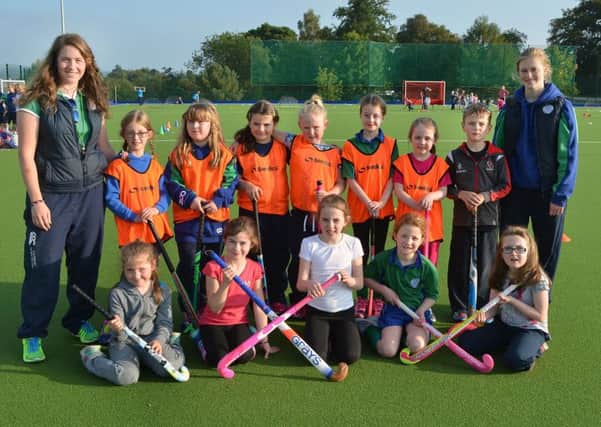 Some of the P4 children with Ballymena Hockey Club coaches Emma Gillespie and Hollie Dickey. INBT 41-811H