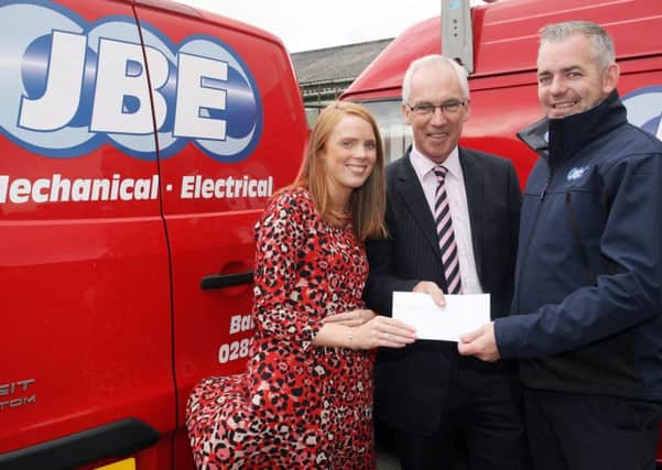 Ruth Clyde and Conor Croskery of JBE are pictured presenting a sponsorship cheque to John Maxwell, chairman of Ballymena Road Club. INBT39-217AC