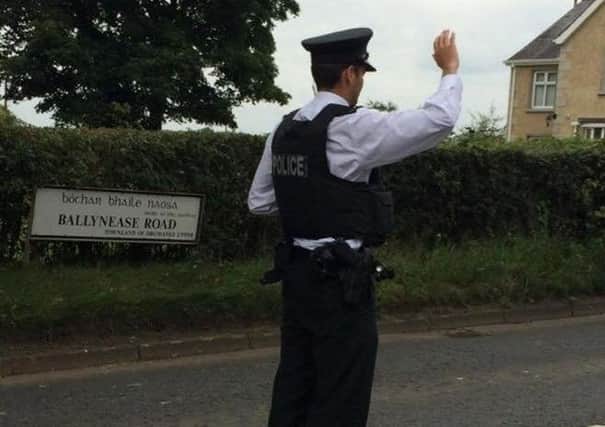 PSNI officer appears to stop traffic in middle of Ballynease Road