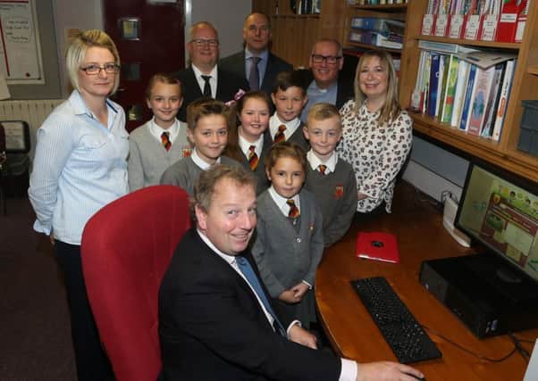 South Antrim MP Danny Kinahan who officially launched the new Antrim Primary School website during his visit to the school last week is seen here with school principal Mr Ian Gourley, chairman of the Board of Governors Dr Stephen McBride, Governor Dr Ian Erskine, office staff Mrs Noelle Monaghan and and Mrs Carolyn Morrison and pupils. INBT 42-308JC