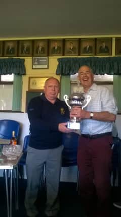 Past President Brian Bates receiving "the Veterans Cup" from Club Captain Stephen Boyd.