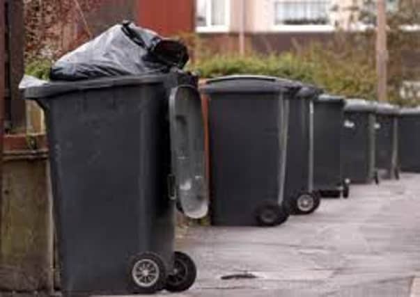 Black waste bins lined up awaiting collection. (Archive pic)