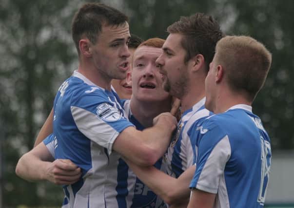 Darren McCauley is congratulated by Brown, McLaughin and Kane after putting the Bannsiders 1-0 ahead at home to Warrenpoint on Saturday. wk41111mb