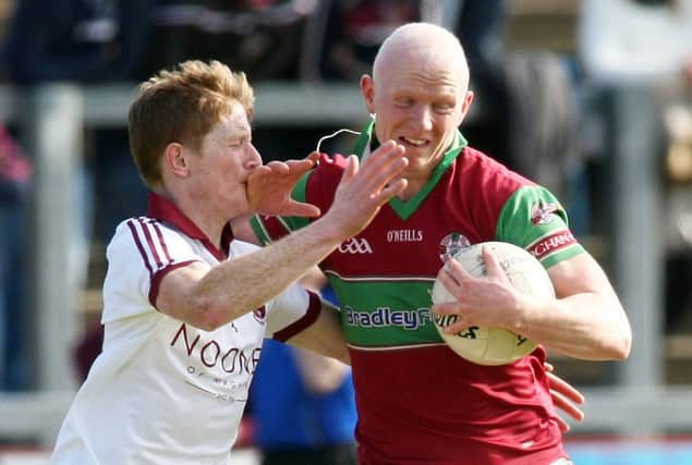 Colm McGoldrick holds off Slaughtneil's Ronan Bradley.
Mandatory Credit Photo Lorcan Doherty / Presseye.com
