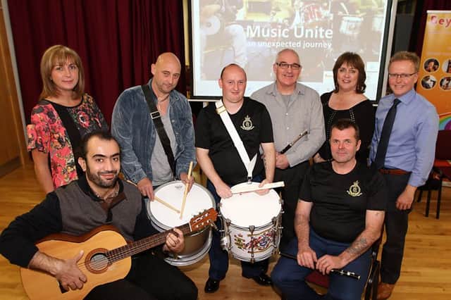Members of the Shankill Road defenders band came together with other cultures and held a concert in the Roe Valley arts Centre this week, included with the muscians who came together ofr Music Unite, An Unexpected Journey, are Patricia Cameron, Joy Wisner and Jonny Donaghy of the Causeway coast and Glens Borough Cluncil. 41275KDR