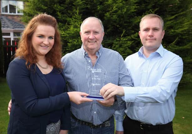 Alan Dade, centre, receives his Carer of the Year award from Karen Fitzmaurice, events manager at Johnston Press, and sponsor Richard Craig, region officer at Lisburn In Focus RNIB. US1540-526cd  Picture: Cliff Donaldson