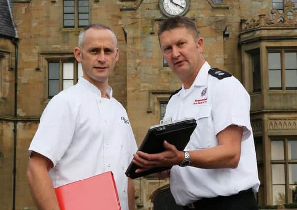 Station Commander Eddie Leahy, NIFRS, with Robert Odgers Manager of Brownlow House, Lurgan during the Fire Safety Audit at the premises which took place during Fire Safety Week 2015