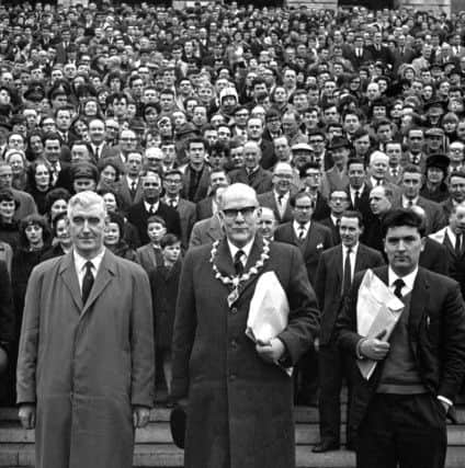Some of the estimated 25,000 who took part in the University for Derry Campaign Motorcade from Derry pose on the steps of Parliament Buildings, Stormont, Belfast, on 18 February 1965. The campaign was lead by (from left) Eddie McAteer, Nationalist MP for Foyle, Albert Anderson, Mayor of Derry, and John Hume, campaign organiser. This last ditch effort to secure the new university for Derry failed as on March 4 1965 the Stormont Parliament voted in favour of the Lockwood Report's choice, Coleraine.