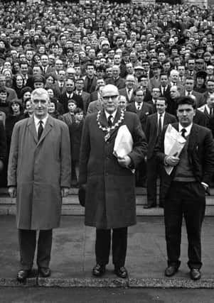 Some of the estimated 25,000 who took part in the University for Derry Campaign Motorcade from Derry pose on the steps of Parliament Buildings, Stormont, Belfast, on 18 February 1965. The campaign was lead by (from left) Eddie McAteer, Nationalist MP for Foyle, Albert Anderson, Mayor of Derry, and John Hume, campaign organiser. This last ditch effort to secure the new university for Derry failed as on March 4 1965 the Stormont Parliament voted in favour of the Lockwood Report's choice, Coleraine.