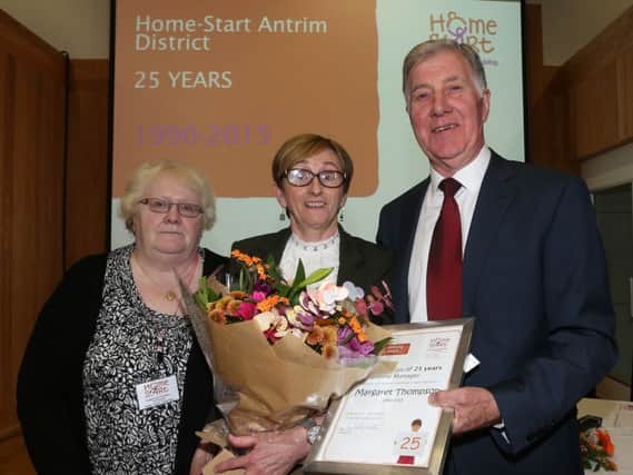 The driving force behind Home-Start in Antrim Margaret Thompson (centre) receives presentation from chairman Philip Scott and volunteer Eileen Emerson at last week's 25th anniversary celebrations in the Old Courthouse. INBT 41-128JC
