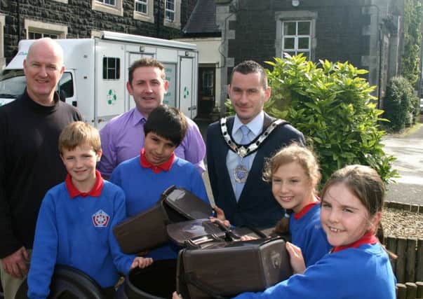 Mid & East Antrim Deputy Mayor Councillor Timothy Gaston pictured with Borough Recycling Officer Barry Tapster, Ballymena Primary School teacher Mr McCullough and pupils, Jack, Jibrail, Leah and Emily at an outdoor lesson in recycling. (Submitted Picture).