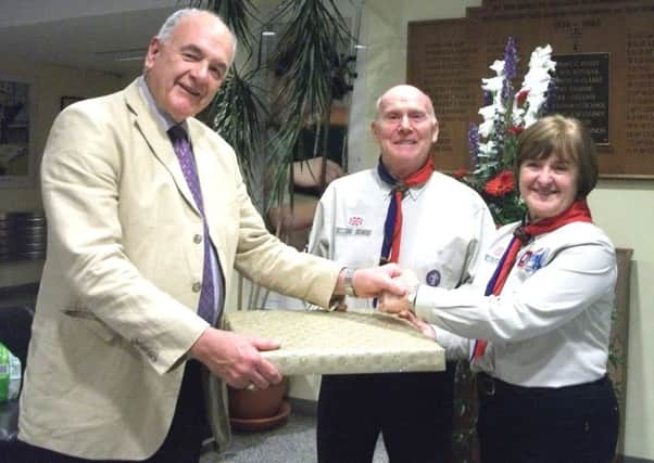 Mr Peter Dawson, Chairman of South East Antrim Scout Council, presents Alex and Marina Powers with a gift of appreciation from the Scout District. INNT 42-501CON