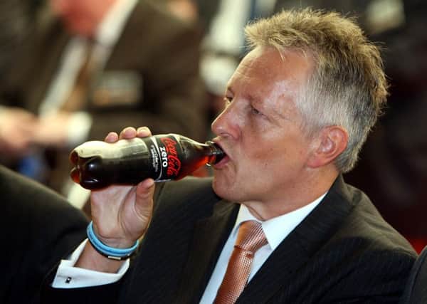 First Minister Peter Robinson drinks a bottle of Coke, as he attends the opening of Coca-Cola's new all-Ireland bottling plant outside Lisburn in Co Antrim. PRESS ASSOCIATION Photo. Issue date: Wednesday September 8, 2010. Photo credit should read: Paul Faith/PA Wire