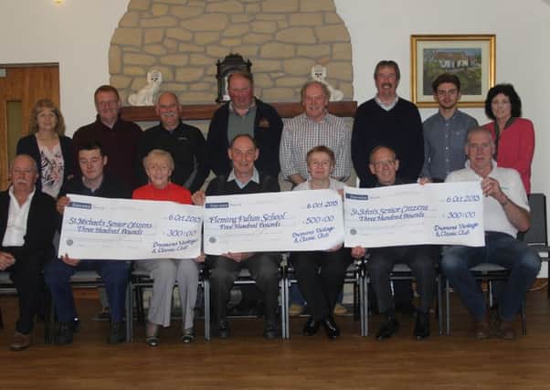 Dromara Vintage and Classic Club chairman Brian McGrillen (seated centre) with cheque recipients and Club members following the official presentation in Peter Morgan's Cottage