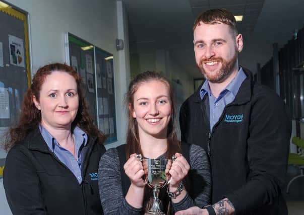 Edel McCrory and Rodney Campbell, from Moyola Precision Engineering, presenting the new Cup to the School for A Level Technology to the 2015 winner Claire Forsythe.INMM39-526.