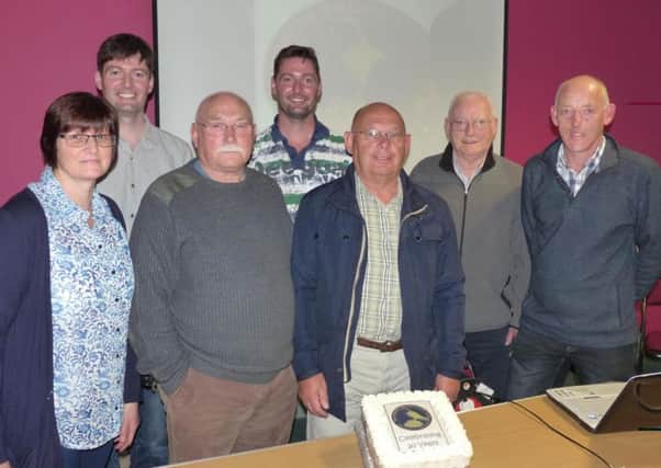 Members of Ballymena Birdwatchers Club pictured prepaing to cut a celebratory cake at their 20th Anniversary meeting in September. (Submitted Picture).