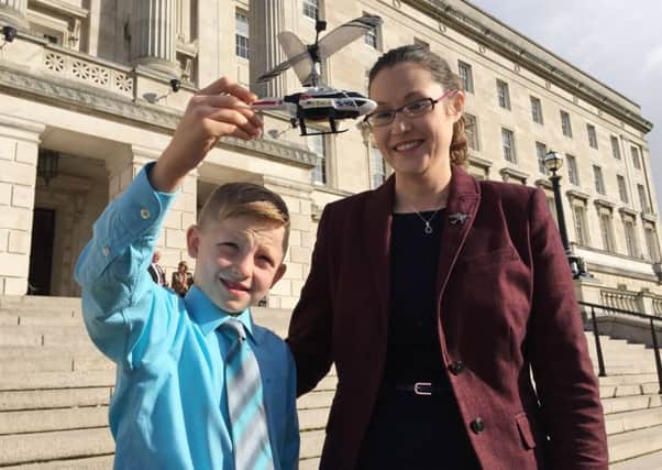 Shaun McCann (left), 7, from Co Roscommon, whose life was saved by Dr John Hinds the "flying doctor", who was killed providing medical cover during a motorcycle race in July, pictured with the Dr Hinds' partner Dr Janet Acheson at Stormont.