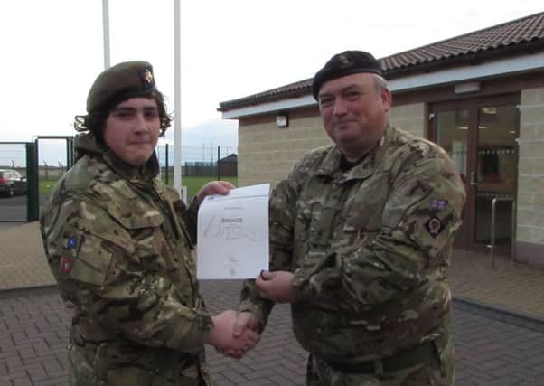 Cadet Joel Roxborough from Cullybackey Detachment receives his Bronze Duke of Edinburgh Award from Major Thomas Robinson, C Company, 1st Battalion, Army Cadet Force. INBT 42- CADETS 2.