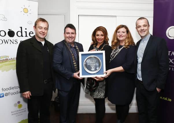 Mayor Elisha McCallion receiving the award for second place in the Foodie Town of Ireland competition presented by RAI President Anthony Gray with Tourism Officer Mary Blake, restaurateur Sean Harrigan from the Sooty Olive, and Kevin Hickey of Tamnagh Foods. Photo: Conor McCabe