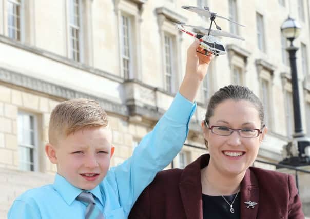 PACEMAKER, BELFAST, 12/10/2015: Dr Janet Acheson, the wife of Dr John Hinds, the travelling motorcycle race doctor who lost his life at Skerries, is pictured with seven year old Shaun McCann at Stormont today where a renewed appeal was made for an emergency medical helicopter service. Dr John had been involved in saving Shaun's life by helicopter after he had a fall at his Roscommon home in 2013.
PICTURE BY STEPHEN DAVISON