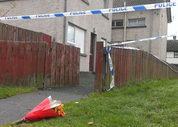 Flowers left outside the flat where Marcell 'Junior' Seeley was found dead yesterday