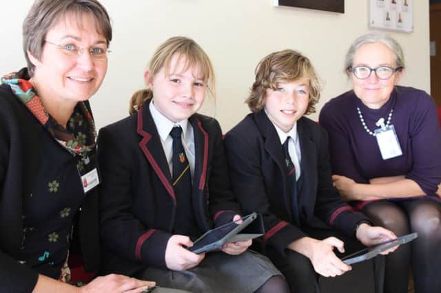 Finish visitors Ms Monica Storgård and Ms Anna-Lena Beckman study the use of iPads in the classroom alongside some Wallace High School pupils.