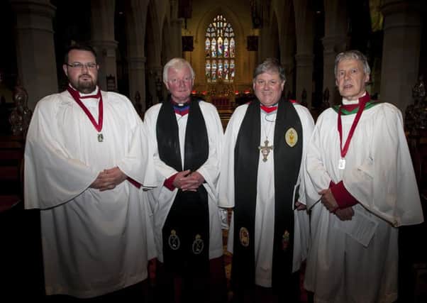 Simon McGonigle and Victor Goodman pictured at St. Columb's Cathedral on Sunday last after receiving their 25 years service medals. Centre are Rev. Canon John Merrick and The Dean of Derry, Very Rev. Dr. William Morton DL. INLS4015MC001
