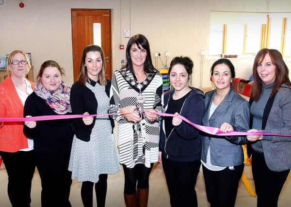 Assisting the Mid-Ulster District Council Chairperson Linda Dillon to officially cut the ribbon to open Brocagh After School Club last Monday morning were from left Linda McCurry, Sheena Woods, Michelle Scullion,  Kathy Donnelly, Mary O'Neill, and  Carmel Canavan.INTT4315-301 PICTURE : Simon Robinson.
